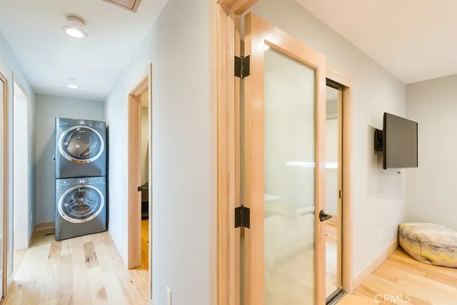 a view of a hallway with bathroom and wooden floor