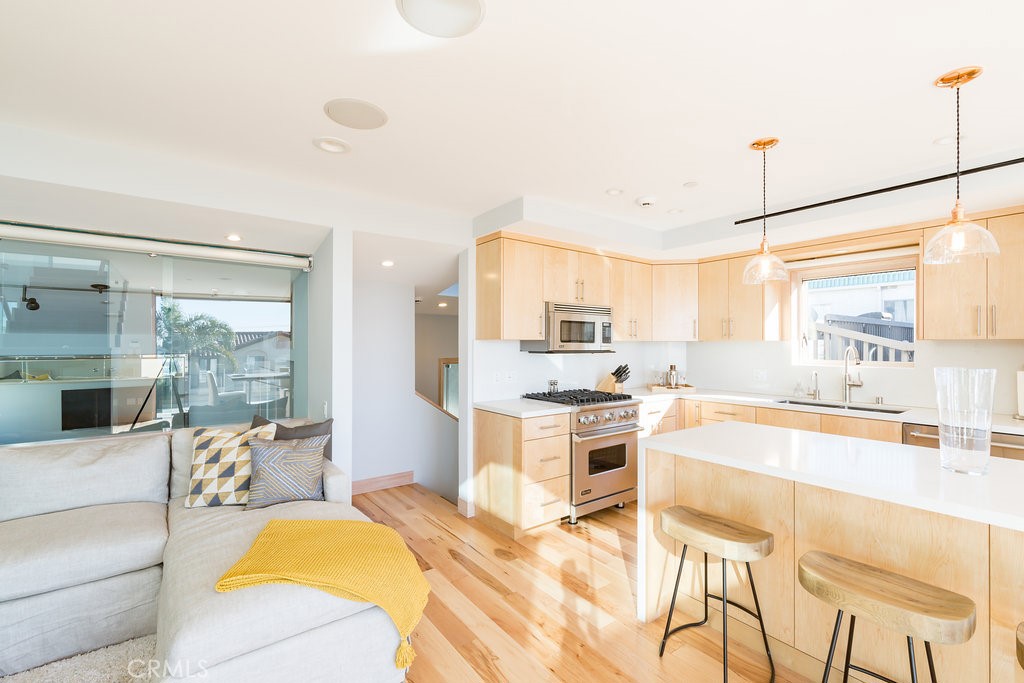 814 Monterey Boulevard Hermosa Beach, CA 90254 - Photo 3 of 28 a large kitchen with kitchen island a large window cabinets and stainless steel appliances