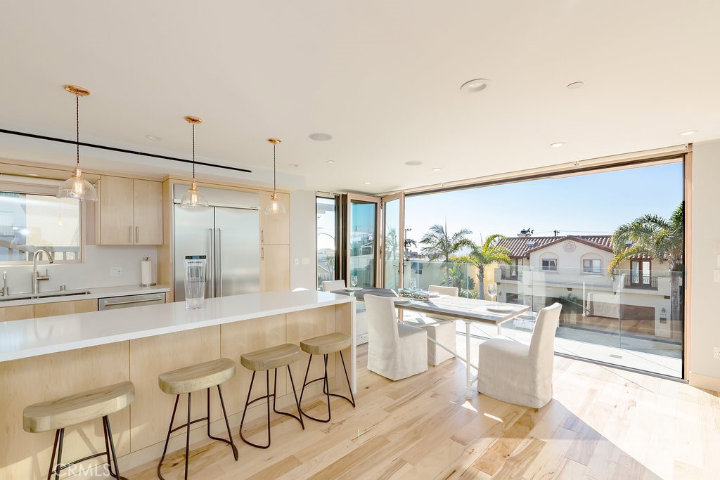 814 Monterey Boulevard Hermosa Beach, CA 90254 - Photo 8 of 28 a large white kitchen with a large window and stainless steel appliances