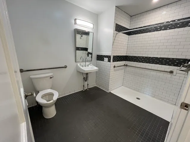 a bathroom with a toilet sink and shower