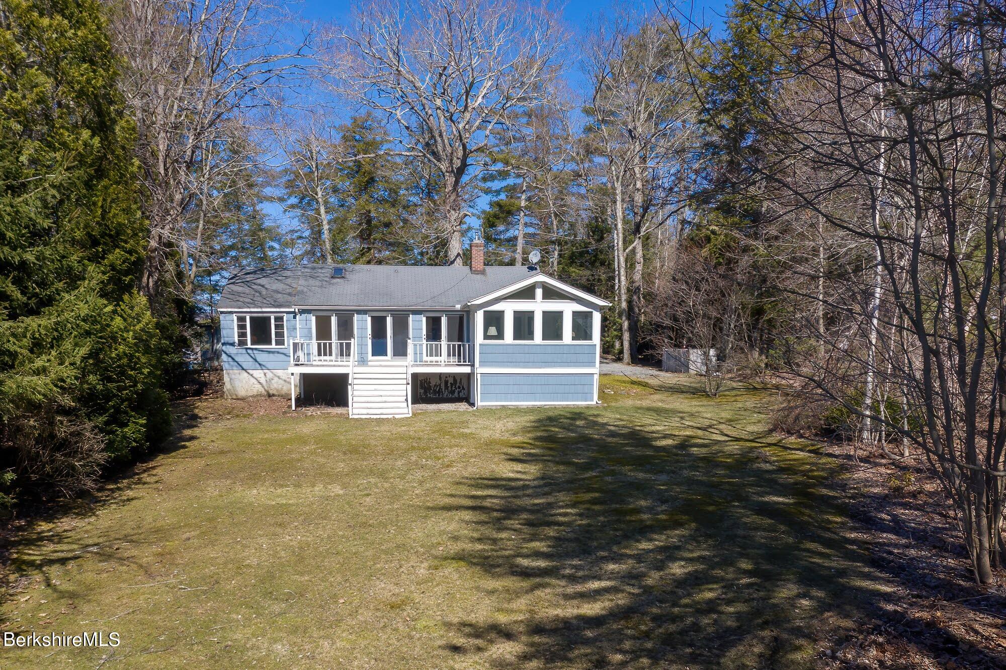 7 Point Road Monterey, MA 01245 - Photo 30 of 41 a front view of a house with a garden and trees