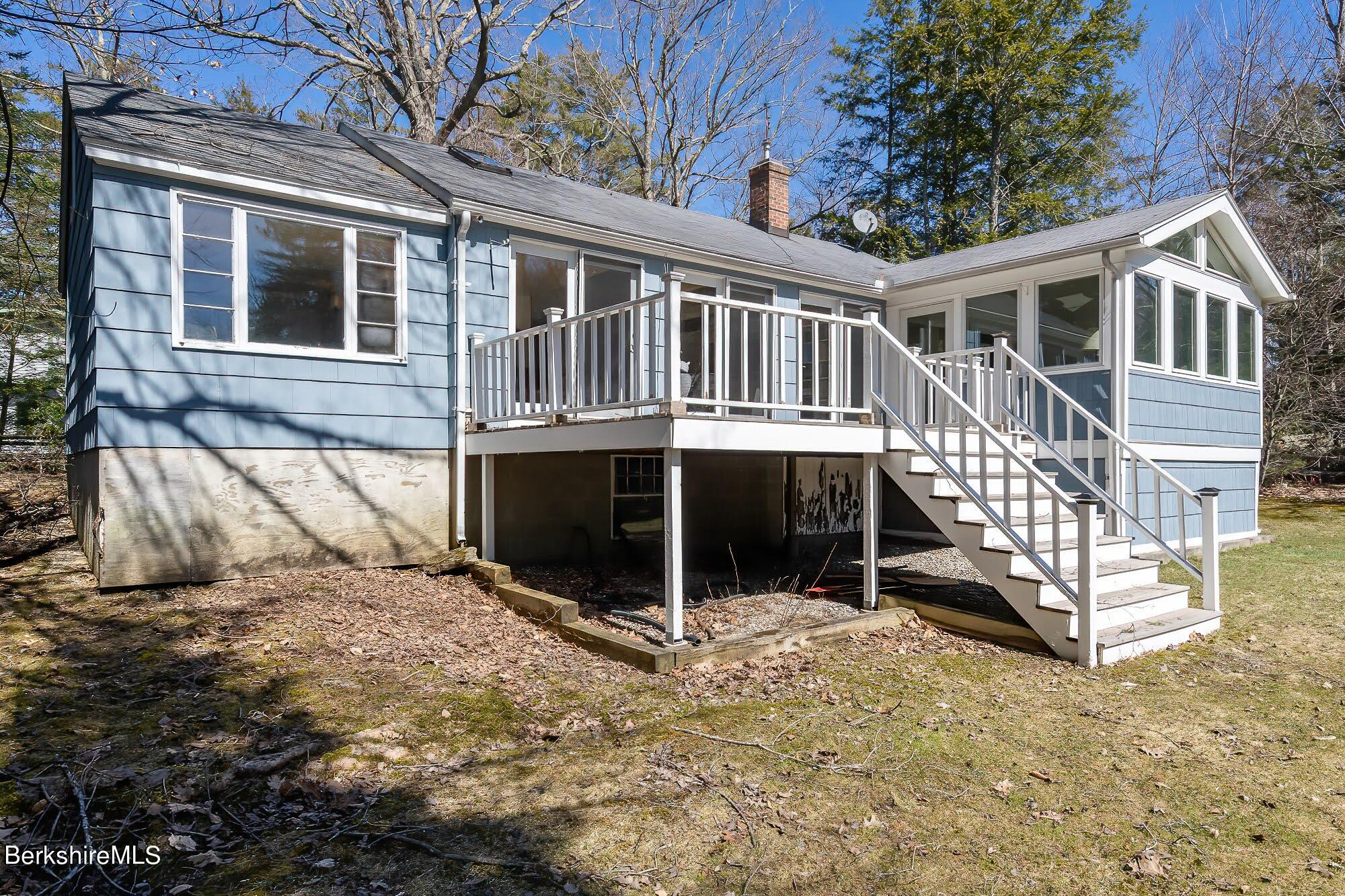 7 Point Road Monterey, MA 01245 - Photo 3 of 41 a view of a house with a yard and wooden fence