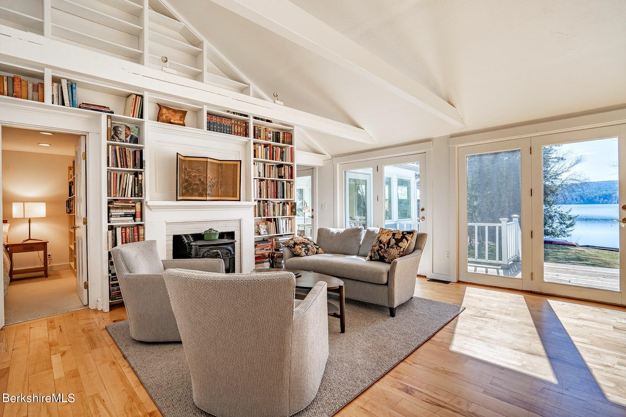 7 Point Road Monterey, MA 01245 - Photo 6 of 41 a living room with fireplace furniture and a floor to ceiling window