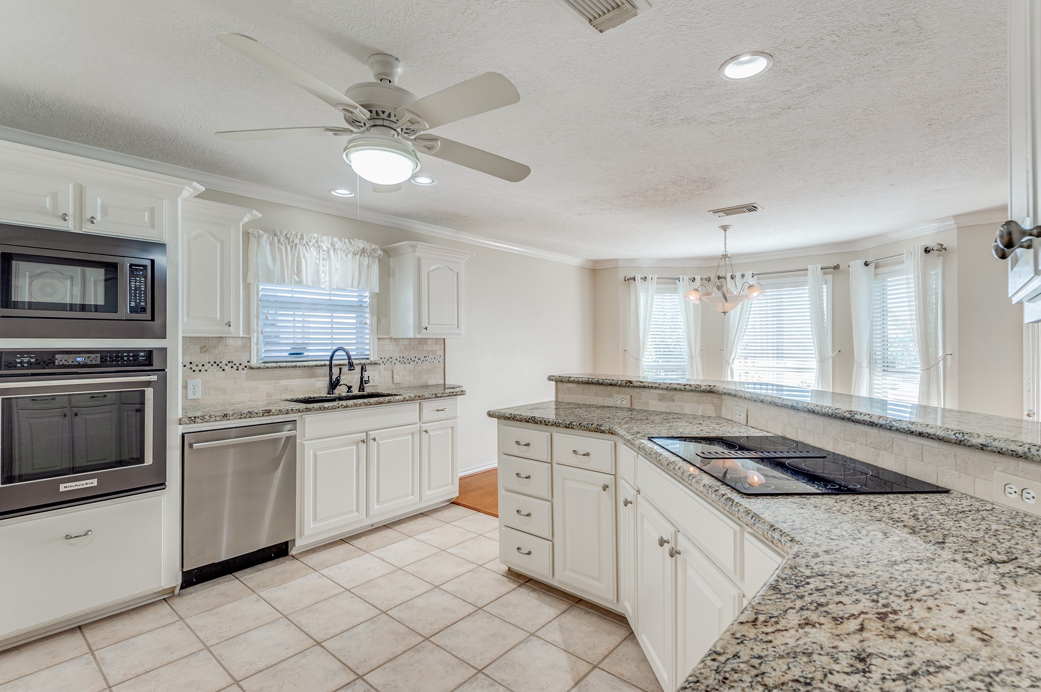 341 Sam Houston Loop Point Blank, TX 77364 - Photo 11 of 36 a kitchen with granite countertop cabinets stainless steel appliances a sink and a window