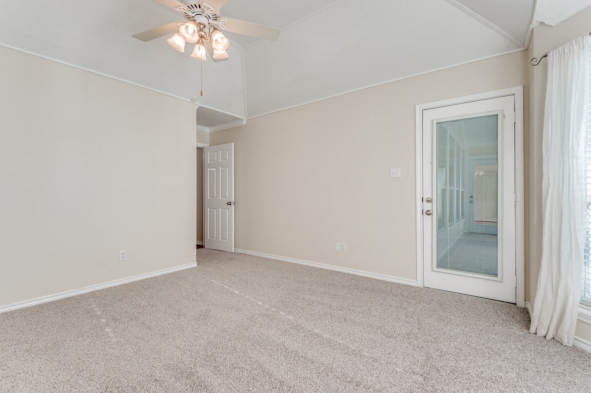 341 Sam Houston Loop Point Blank, TX 77364 - Photo 14 of 36 a view of an empty room with a chandelier fan