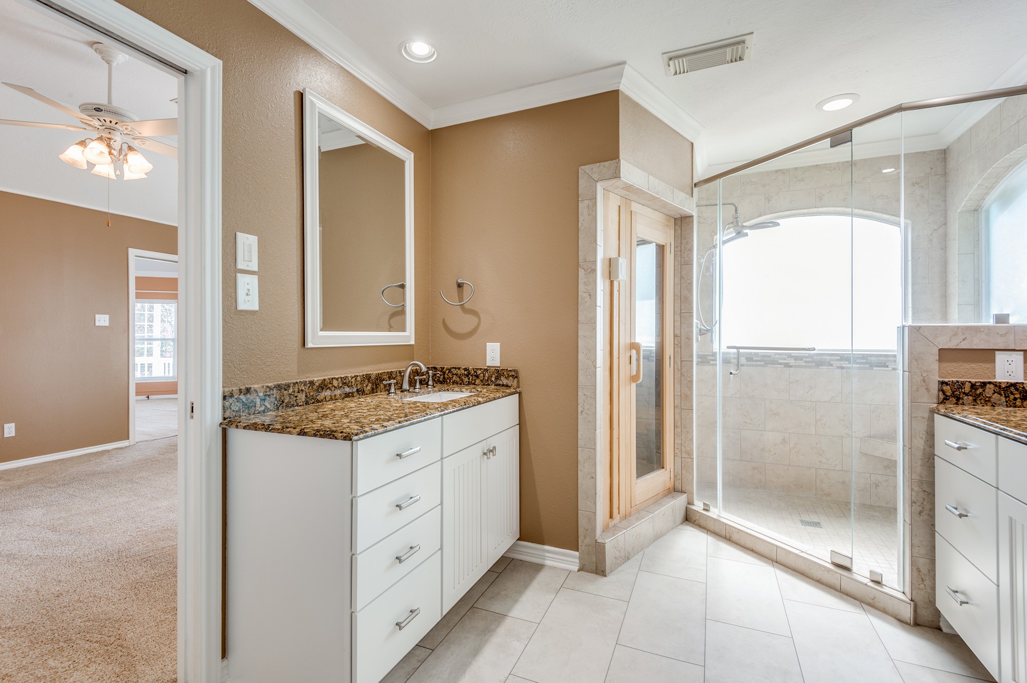 341 Sam Houston Loop Point Blank, TX 77364 - Photo 17 of 36 a bathroom with a granite countertop sink a mirror and a glass door shower