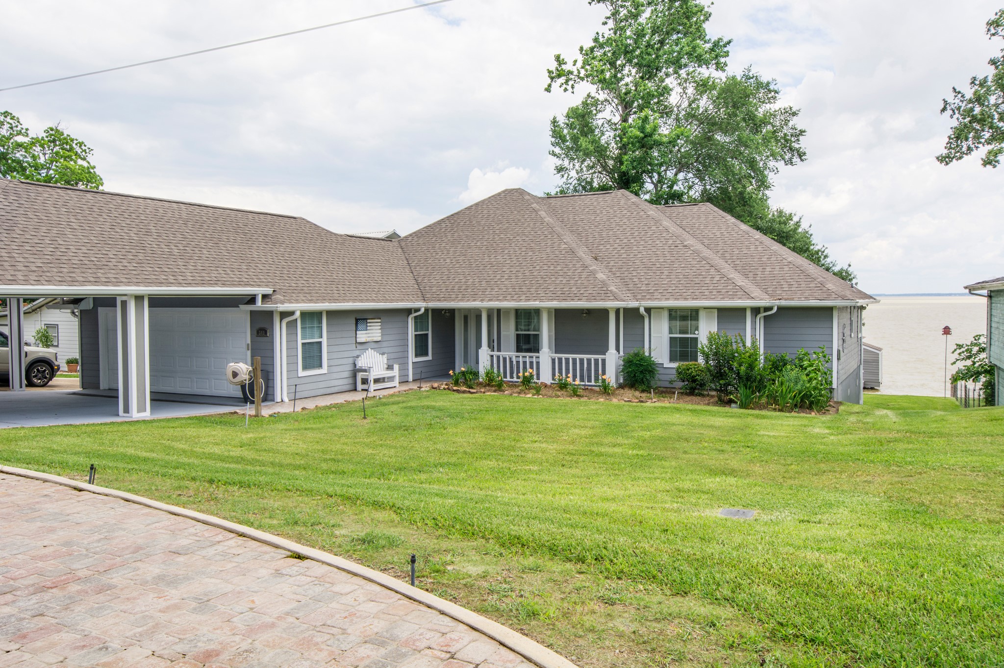341 Sam Houston Loop Point Blank, TX 77364 - Photo 2 of 36 a front view of a house with a garden