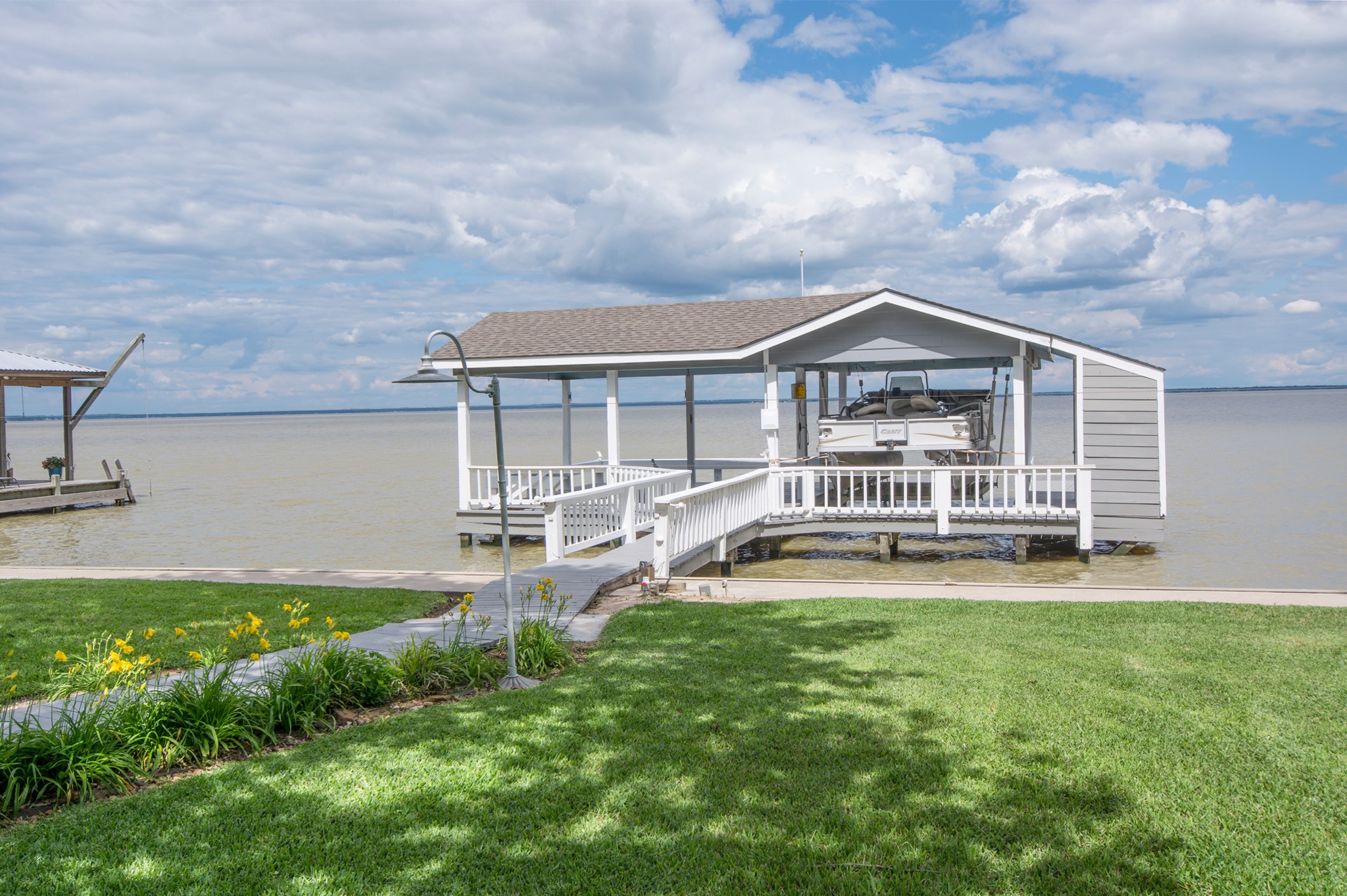 341 Sam Houston Loop Point Blank, TX 77364 - Photo 34 of 36 a view of a house with a yard and sitting area