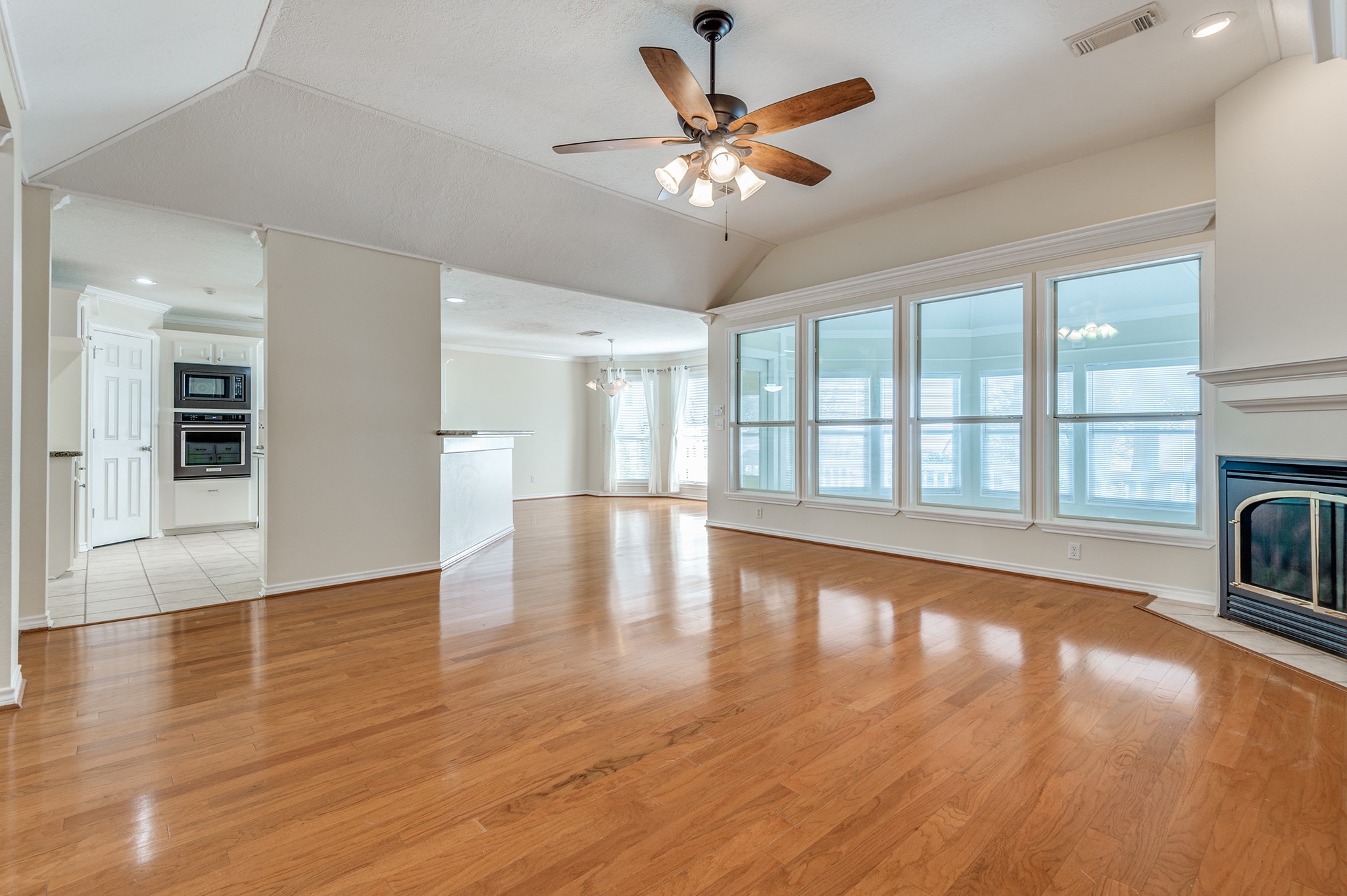 341 Sam Houston Loop Point Blank, TX 77364 - Photo 5 of 36 a view of an empty room with window and wooden floor