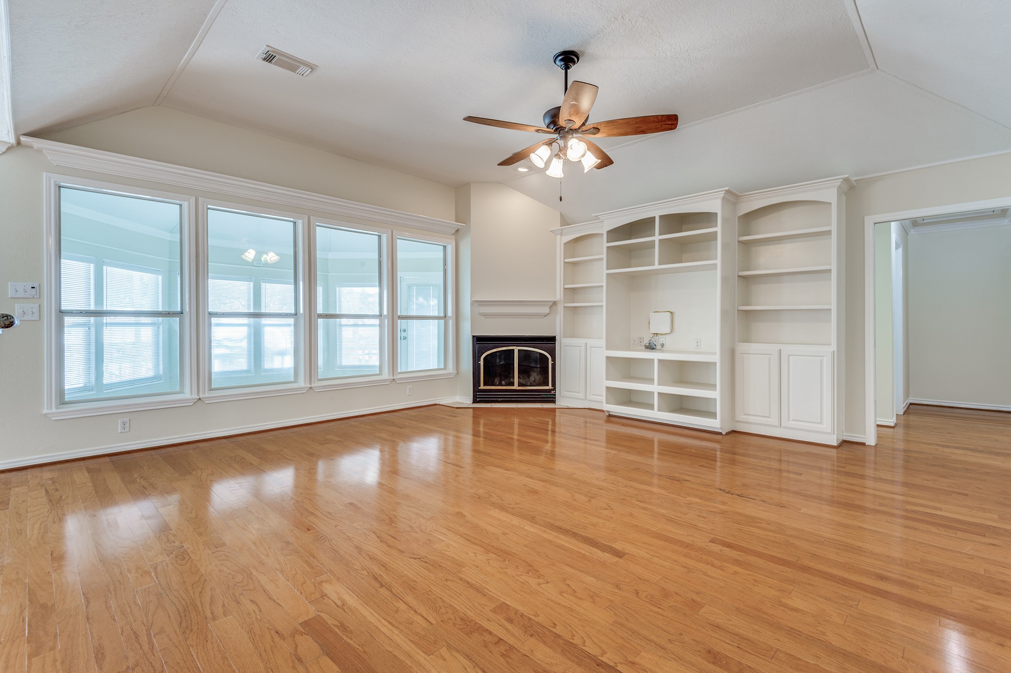 341 Sam Houston Loop Point Blank, TX 77364 - Photo 6 of 36 a view of an empty room with a window and wooden floor