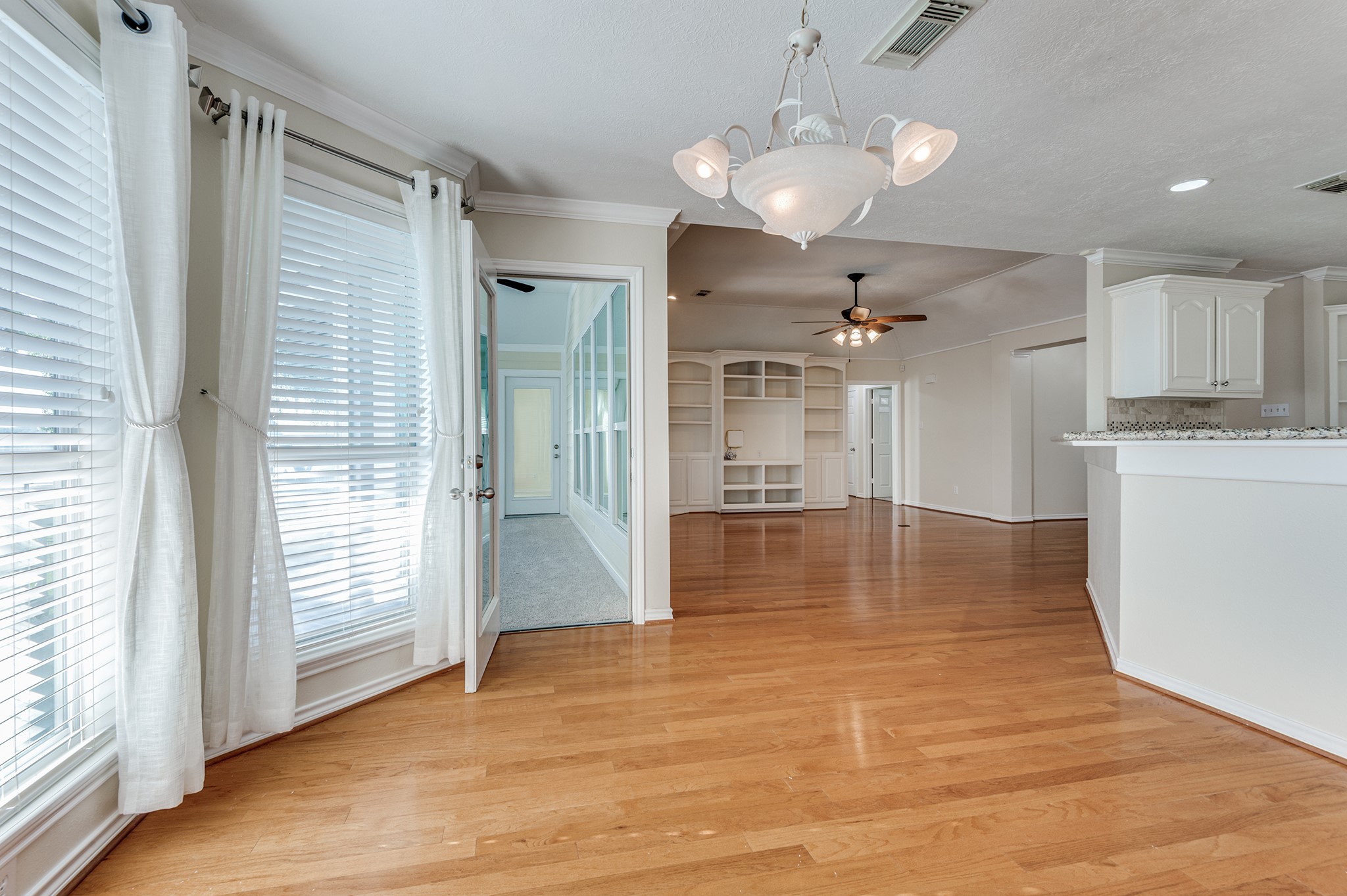 341 Sam Houston Loop Point Blank, TX 77364 - Photo 9 of 36 a view of a hallway with wooden floor and a kitchen