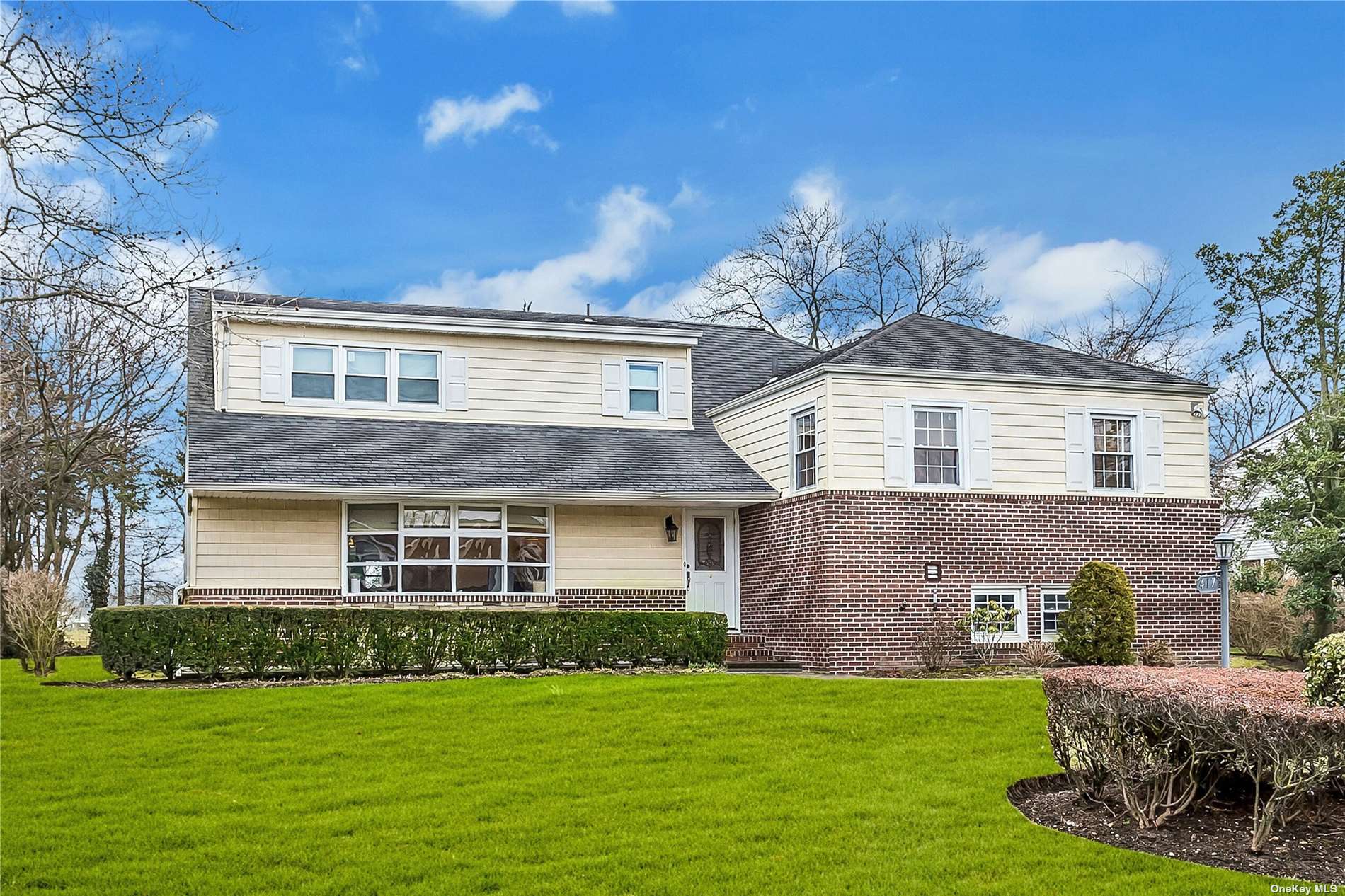 a front view of a house with a garden