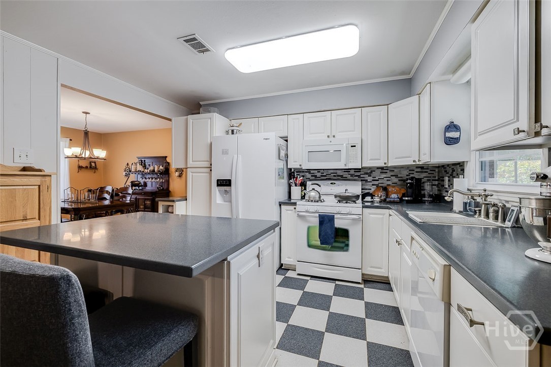 12606 Sunnybrook Road Savannah, GA 31419 - Photo 10 of 39 Kitchen with tile flooring, solid counters and newer refrigerator
