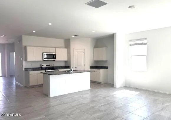a kitchen with granite countertop a sink and a stove top oven
