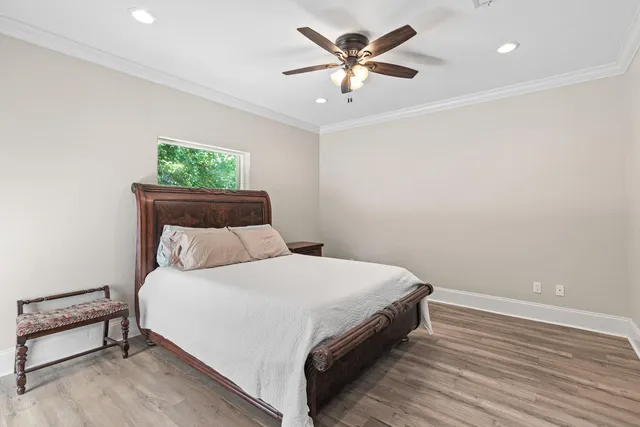 a bedroom with a bed and a potted plant