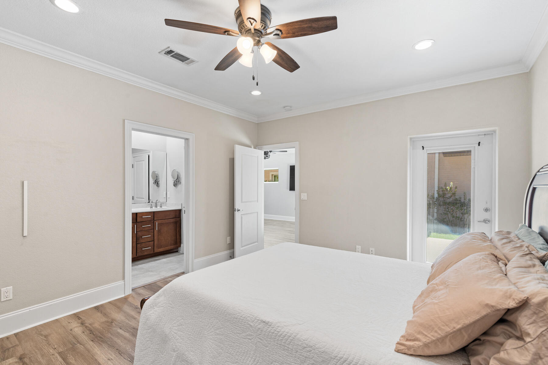 496 Soundview Court Mary Esther, FL 32569 - Photo 13 of 40 a bedroom with a large bed and a chandelier