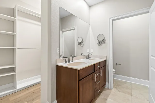 a bathroom with a sink vanity and a mirror