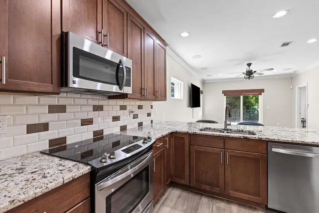 a kitchen with a sink stove and microwave