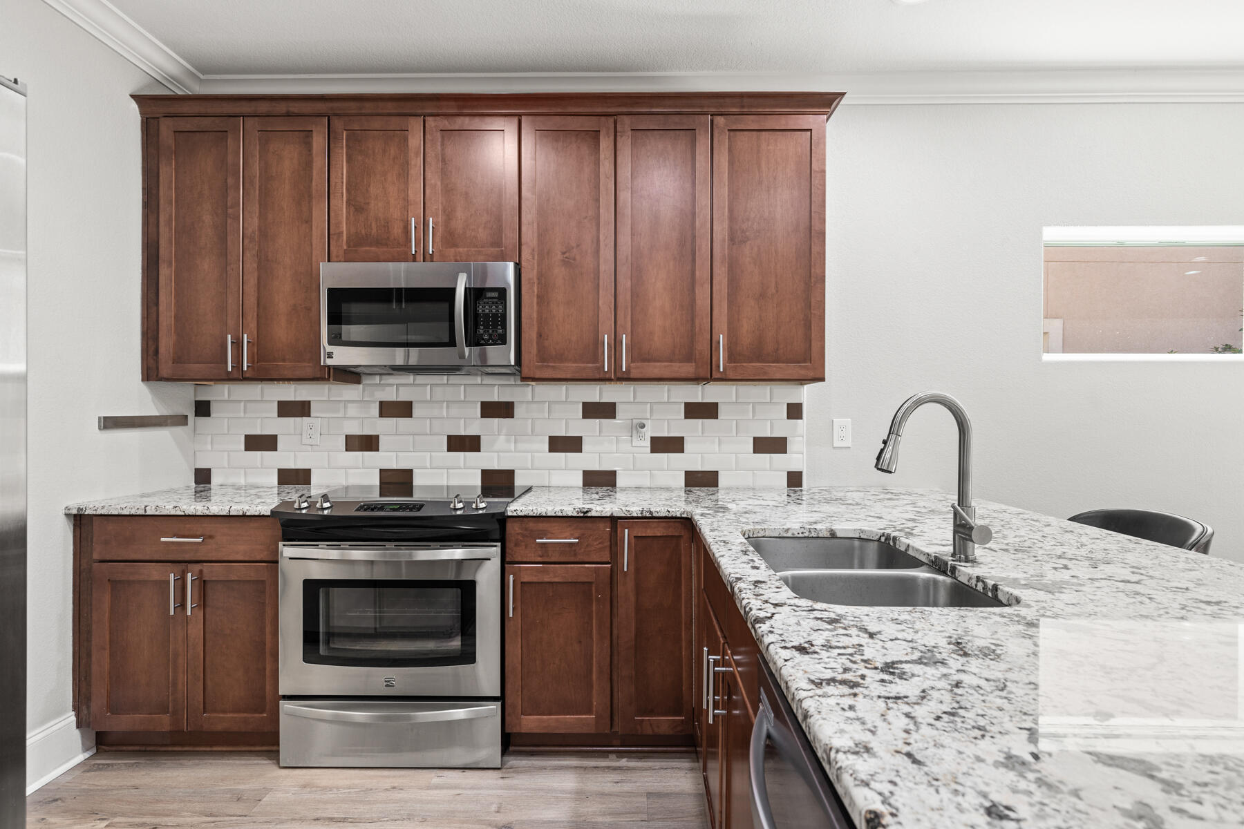 496 Soundview Court Mary Esther, FL 32569 - Photo 4 of 40 a kitchen with granite countertop wooden cabinets a sink and stainless steel appliances