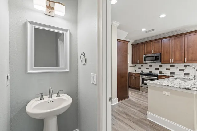 a kitchen with sink a microwave and refrigerator