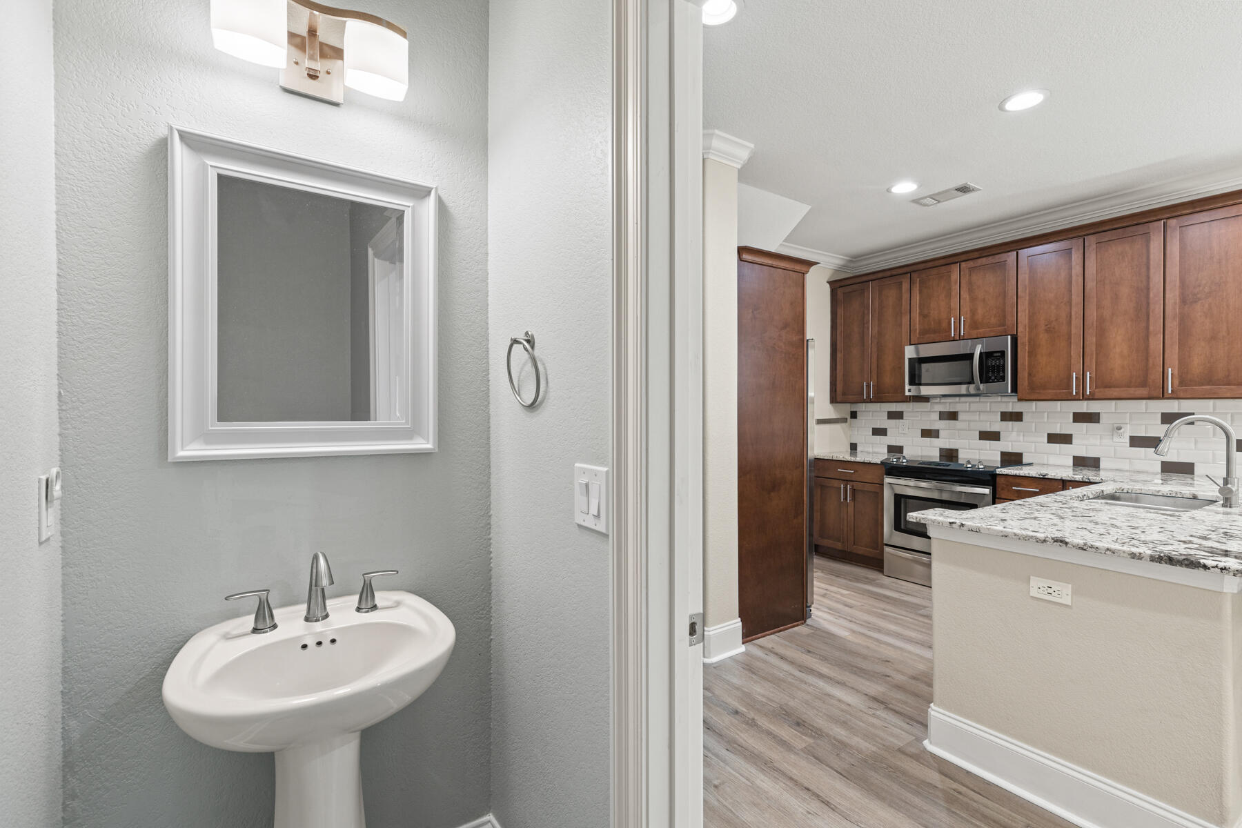 496 Soundview Court Mary Esther, FL 32569 - Photo 7 of 40 a kitchen with sink a microwave and refrigerator