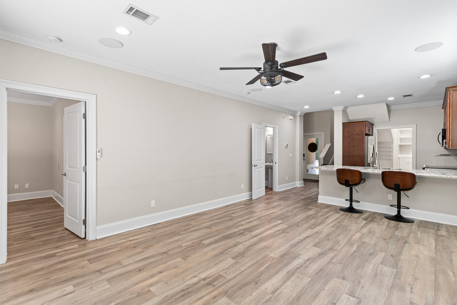 496 Soundview Court Mary Esther, FL 32569 - Photo 10 of 40 a living room with wooden floor and a ceiling fan