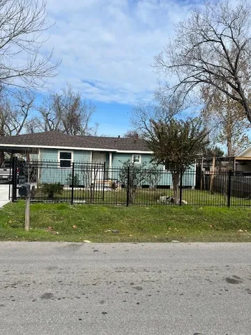 a view of a house with a yard and sitting area