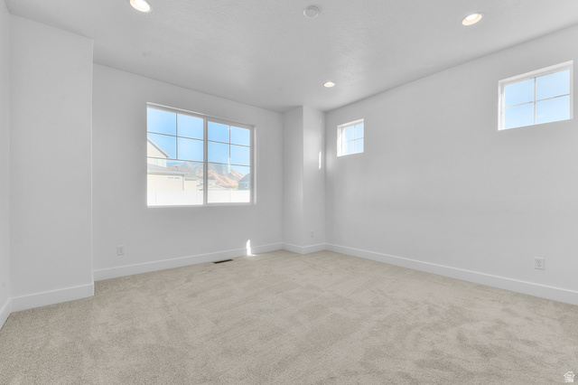 5644 Ibis Road Tooele, UT 84074 - Photo 17 of 19 Spacious room featuring light-toned carpeting, white walls, and recessed lighting