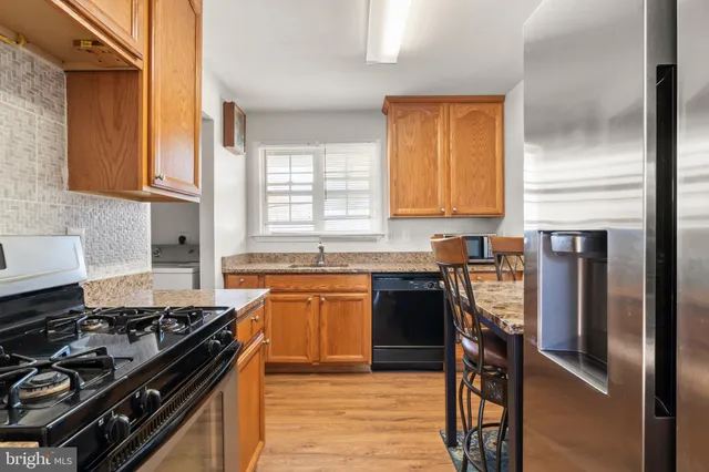 a kitchen with a stove a sink and a refrigerator