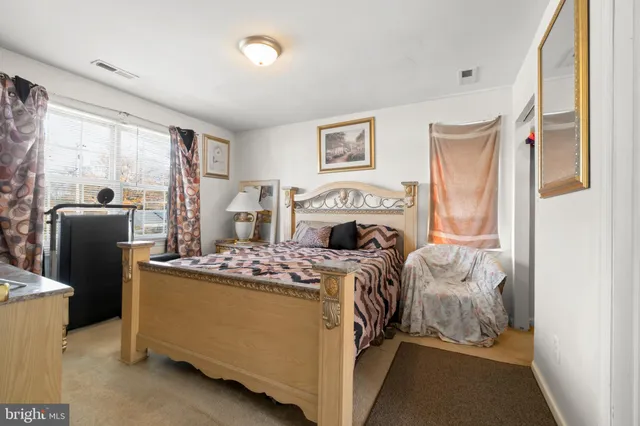 a bedroom with a bed and a fireplace