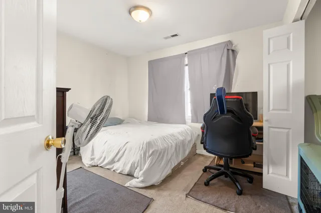 a bedroom with a bed and a desk