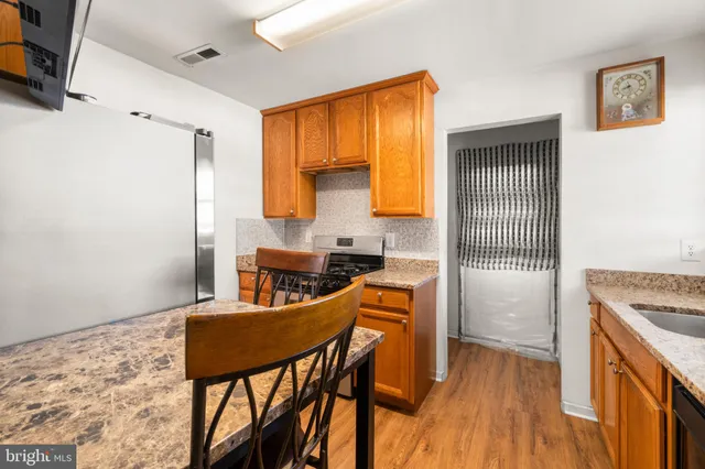 a kitchen with stainless steel appliances granite countertop a stove a sink refrigerator and a microwave