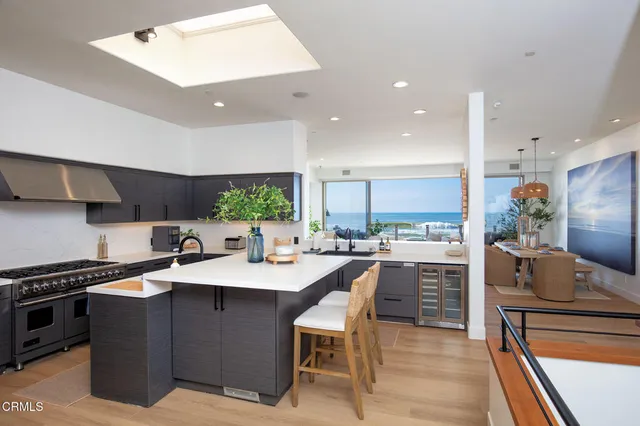 a kitchen with stainless steel appliances kitchen island granite countertop a sink and cabinets