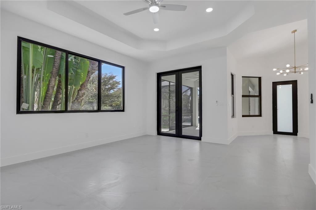 730 29th Street Southwest Naples, FL 34117 - Photo 22 of 50 Unfurnished room featuring finished concrete floors and ceiling fan