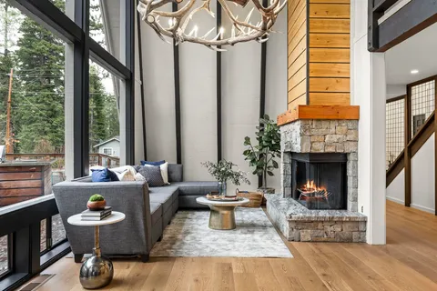 a living room with patio fireplace furniture and a fireplace