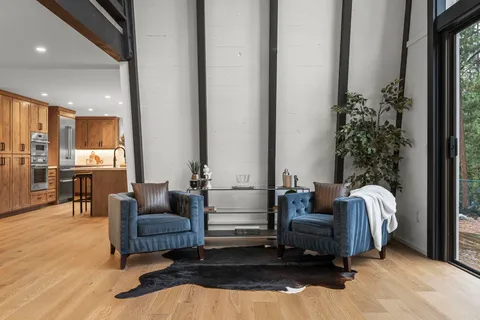 a living room with furniture flowerpot and wooden floor