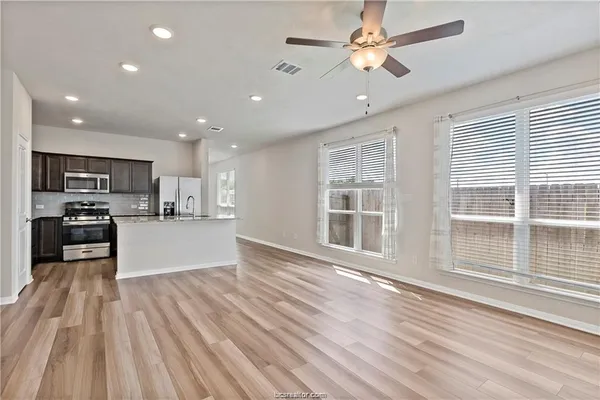 a view of kitchen with sink and wooden floor