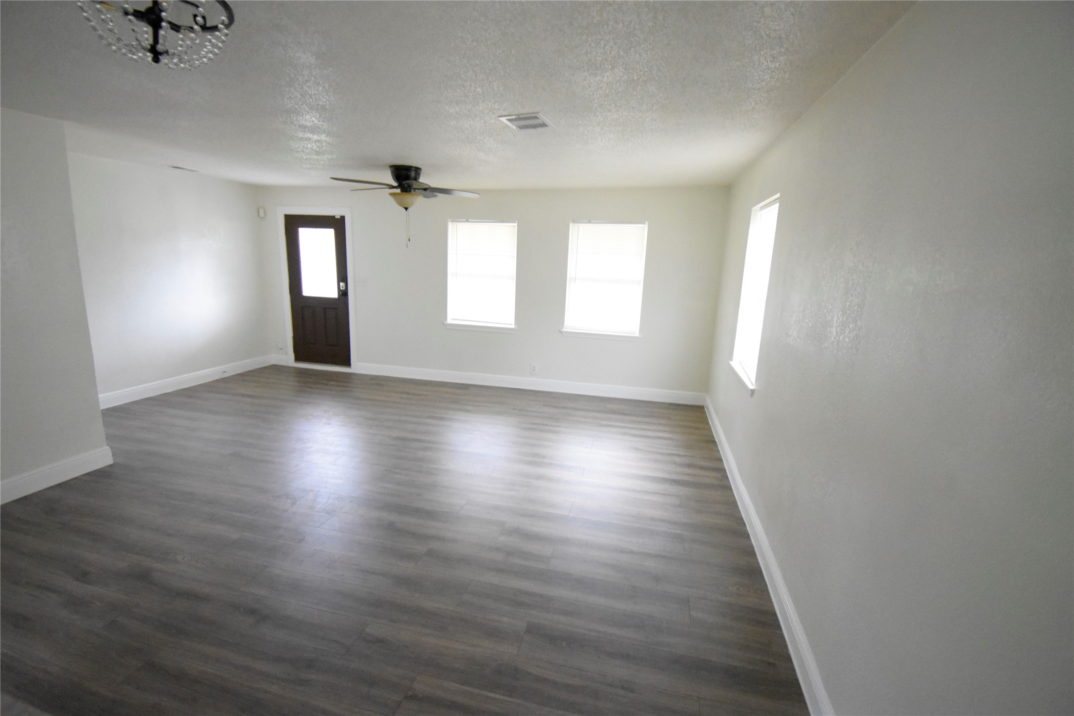 6229 Clover Ridge Street Houston, TX 77087 - Photo 12 of 25 an empty room with wooden floor and windows