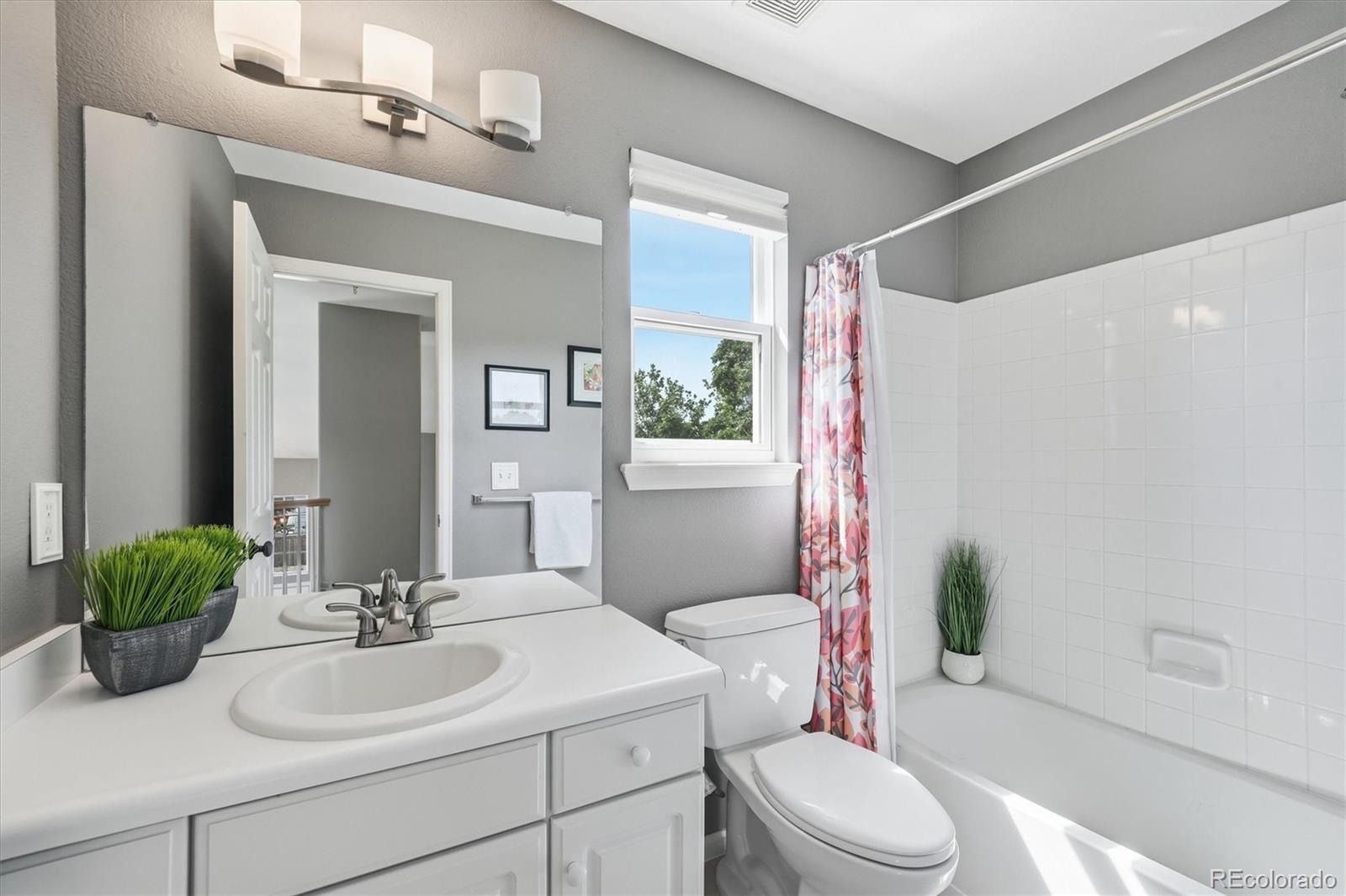 9629 Burberry Way Highlands Ranch, CO 80129 - Photo 32 of 50 a bathroom with a sink a toilet a mirror and shower