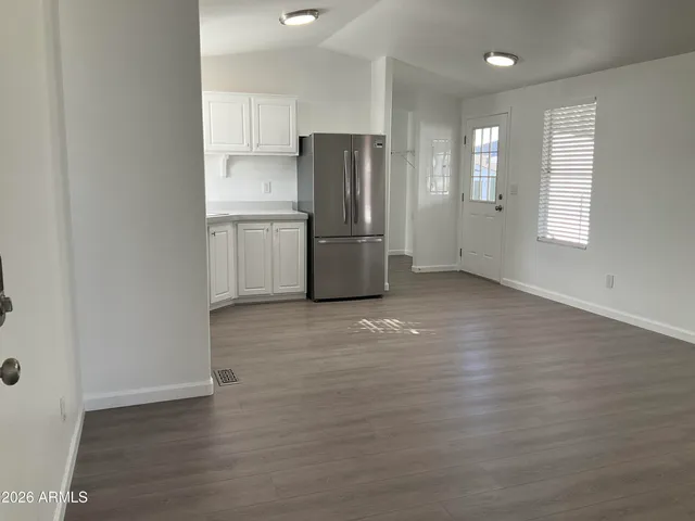 a kitchen with stainless steel appliances wooden cabinets and a refrigerator