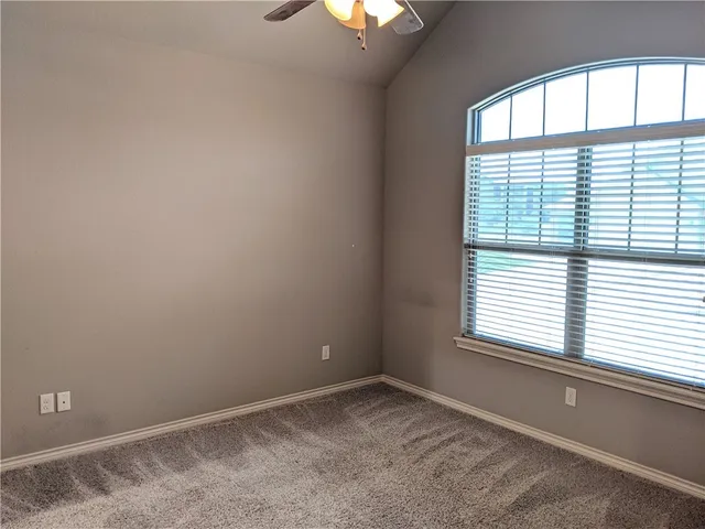 a view of a hallway with wooden floor and a livingroom