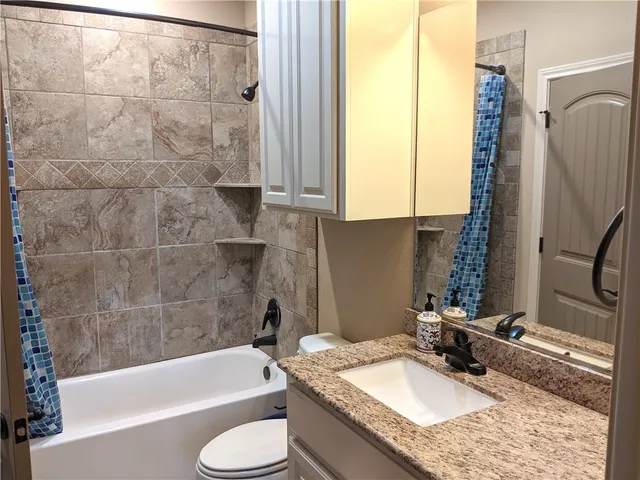 a bedroom with a bed and a shower