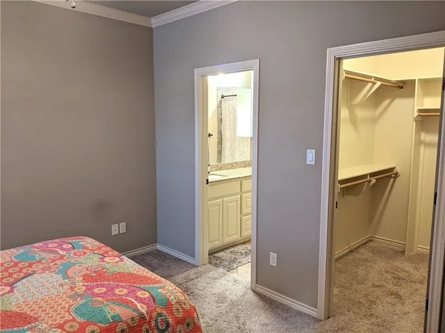 a bedroom with a bed and a potted plant