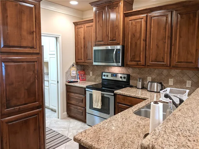a view of bathroom with a refrigerator and mirror