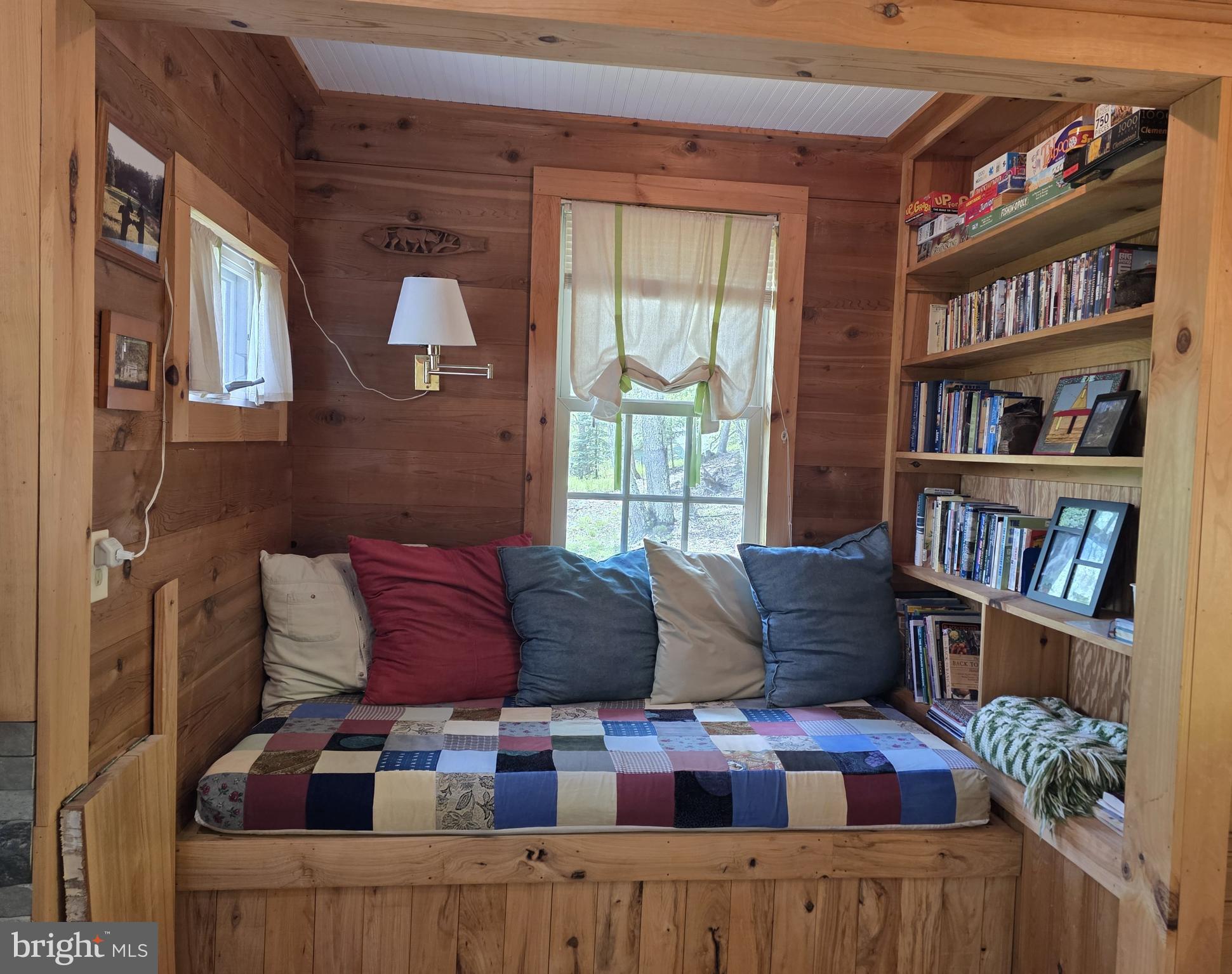 152 Sharp Ridge Lane Franklin, WV 26807 - Photo 8 of 53 a living room with furniture and a book shelf