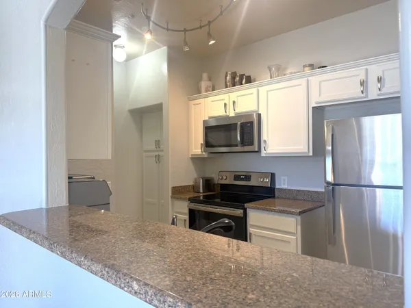 a kitchen with a refrigerator and a sink