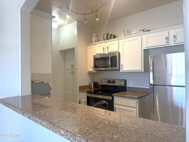 a kitchen with a refrigerator and a sink