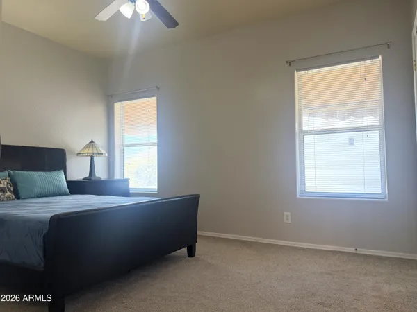 a living room with a bed furniture and a window