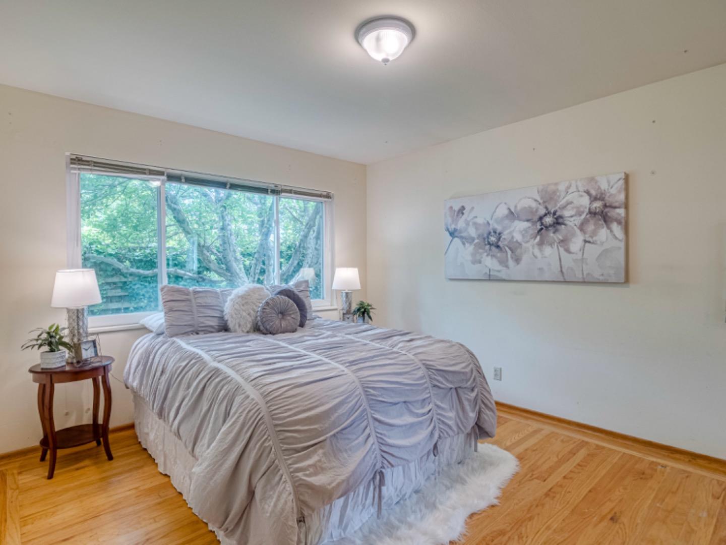 1122 Merrimac Drive Sunnyvale, CA 94087 - Photo 15 of 26 a bedroom with a bed and a large window