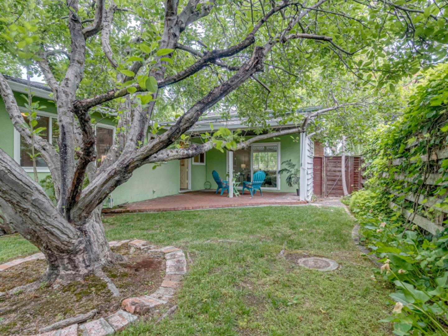 1122 Merrimac Drive Sunnyvale, CA 94087 - Photo 25 of 26 a view of backyard with table and chairs and a large tree